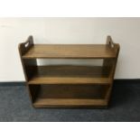 An oak three tier book trolley