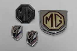 Two MG car badges and two Ghia badges