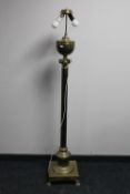 An antique brass Corinthian column standard lamp (continental wiring)