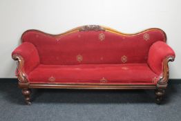 A Victorian mahogany shaped arm settee in red fabric