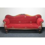 A Victorian mahogany shaped arm settee in red fabric