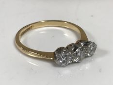 An 18ct gold three stone diamond ring, the total diamond weight estimated at 0.