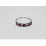 A 14ct white gold ruby and diamond ring featuring five round cut natural rubies 0.