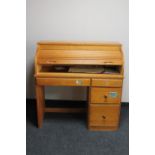 A contemporary pine roll top desk