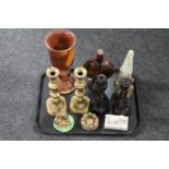 A tray of treen goblet, pair of brass candlesticks, amethyst glass candlesticks,