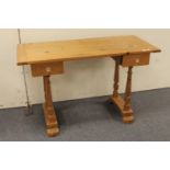 A pine two drawer writing desk