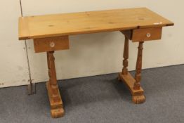 A pine two drawer writing desk