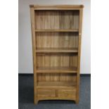 A set of contemporary oak open bookshelves