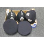 A box of five police helmets