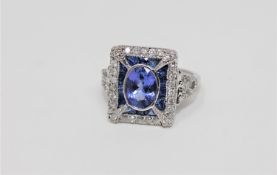 An 18ct white gold tanzanite sapphire and diamond ring, oval cut bezel set with natural tanzanite 0.