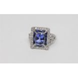 An 18ct white gold tanzanite sapphire and diamond ring, oval cut bezel set with natural tanzanite 0.