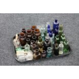 A tray of a large quantity of antique glass chemists bottle and jars
