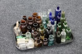 A tray of a large quantity of antique glass chemists bottle and jars