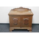 A 20th century continental oak double door cabinet with walnut panelled doors