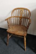 An antique elm Windsor armchair of small proportions