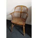 An antique elm Windsor armchair of small proportions