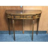 A shaped hall table on reeded legs fitted a drawer CONDITION REPORT: 99cm wide by