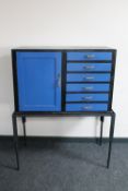 A painted cabinet fitted six drawers on metal stand