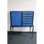 A painted cabinet fitted six drawers on metal stand