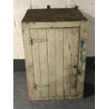 An antique pitch pine singled door cupboard,