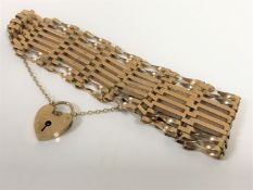 A 9ct gold padlock bracelet CONDITION REPORT: 16.