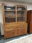 A Barker & Stonehouse hardwood sliding door bookcase fitted cupboards beneath,