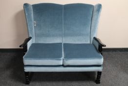 A 20th century wing back two seater settee