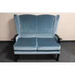 A 20th century wing back two seater settee