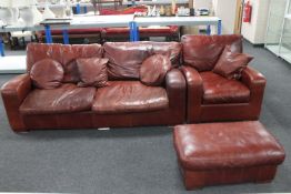 A tan leather two seater settee with matching armchair and footstool plus four scatter cushions