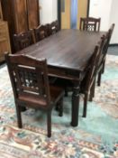 A hardwood dining table and matching set of eight chairs