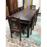 A hardwood dining table and matching set of eight chairs