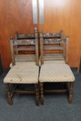 A set of four antique carved oak dining chairs