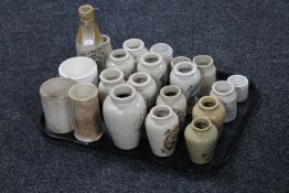 A tray containing approximately twenty-one cream ware bottles and kitchen jars,