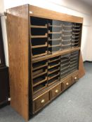 An early 20th century haberdashery chest fitted forty-four pull out drawers an four drawers