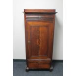 An antique continental mahogany sentry door cabinet