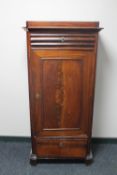 An antique continental mahogany sentry door cabinet