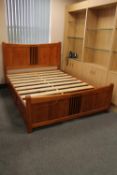 A 5' pine bed framed fitted storage drawers beneath