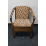 A mid 20th century commode armchair