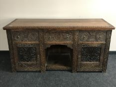 A Victorian carved oak sideboard,