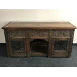 A Victorian carved oak sideboard,