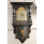 An antique oak cased wall clock with brass dial,
