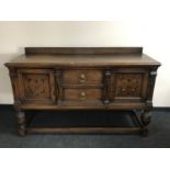 A Victorian oak sideboard with inlaid panel doors,