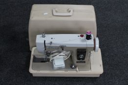 A New Home electric sewing machine in case