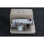 A New Home electric sewing machine in case