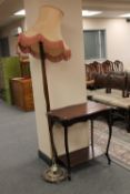 An Edwardian mahogany two tier table together with a standard lamp with shade