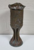 An embossed trench art shell vase