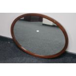 An inlaid mahogany Victorian oval framed mirror