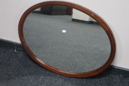 An inlaid mahogany Victorian oval framed mirror