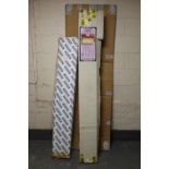 A box of carpet grip rods together with a flat packed radiator cabinet
