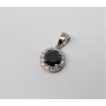 A 14ct white gold black diamond pendant featuring one round brilliant cut natural black diamond 1.